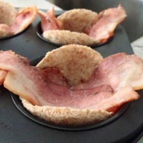 Line the bacon on top of the toast in the muffin cup