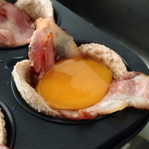 Crack an egg into the cup